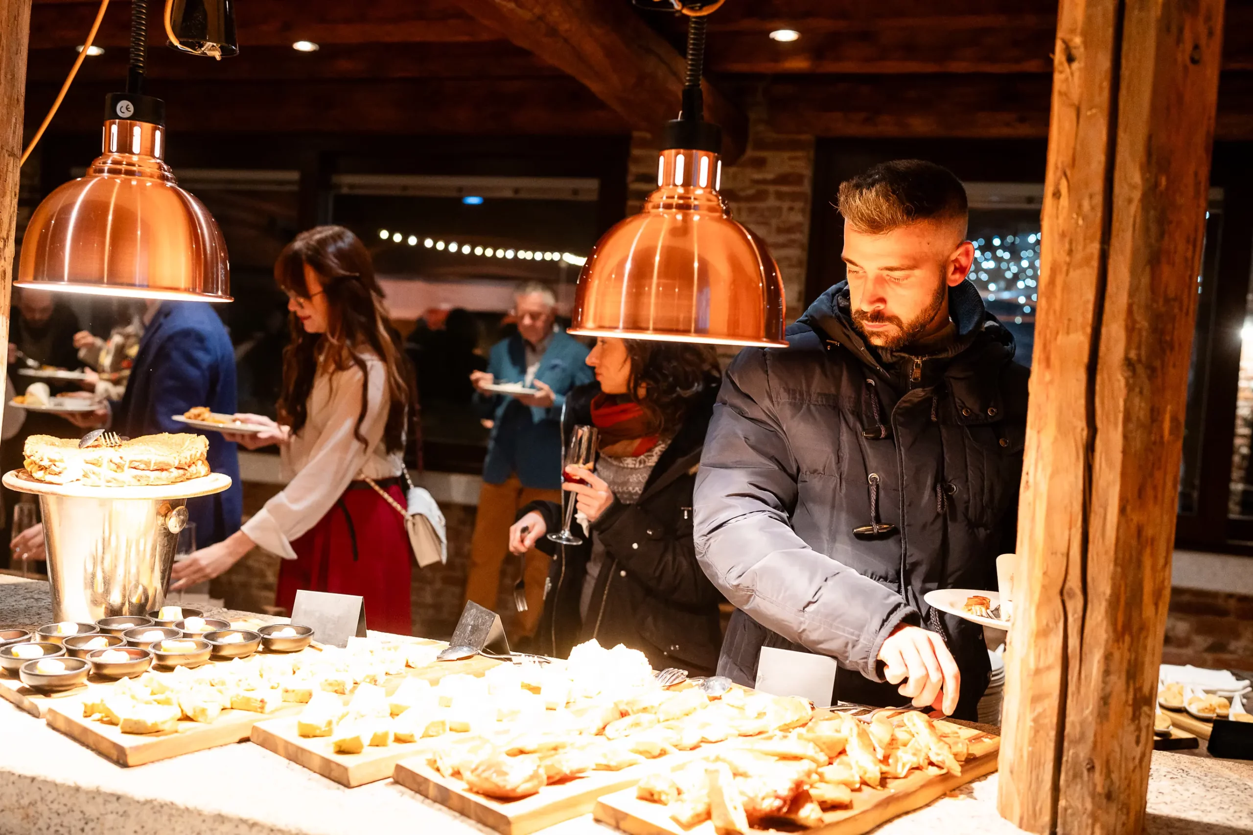 Ospiti si servono dal buffet serale illuminato nella Veranda
